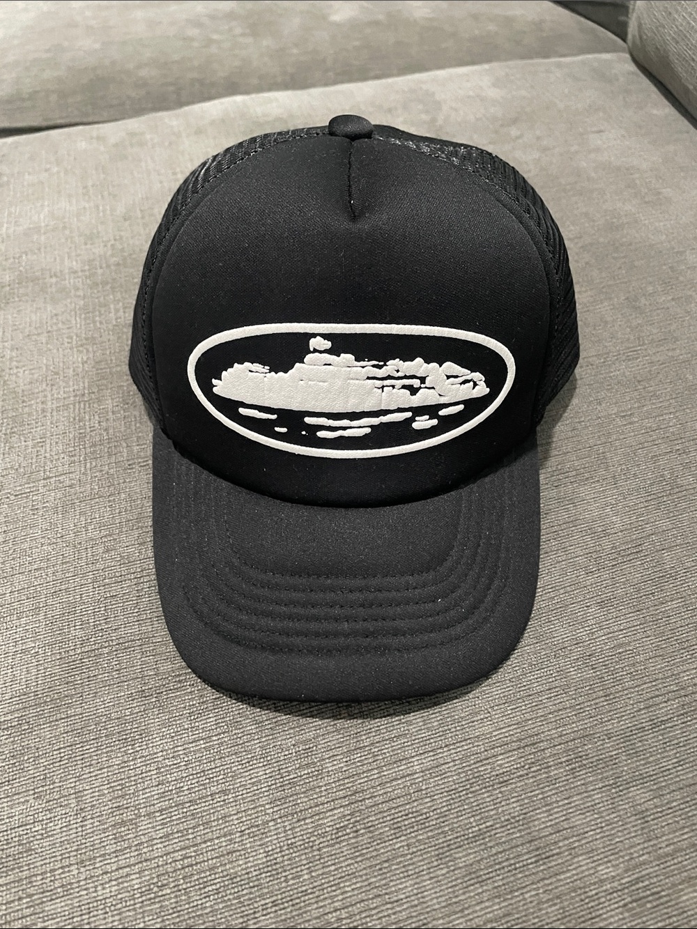 Black Trucker Cap with White Oval Graphic